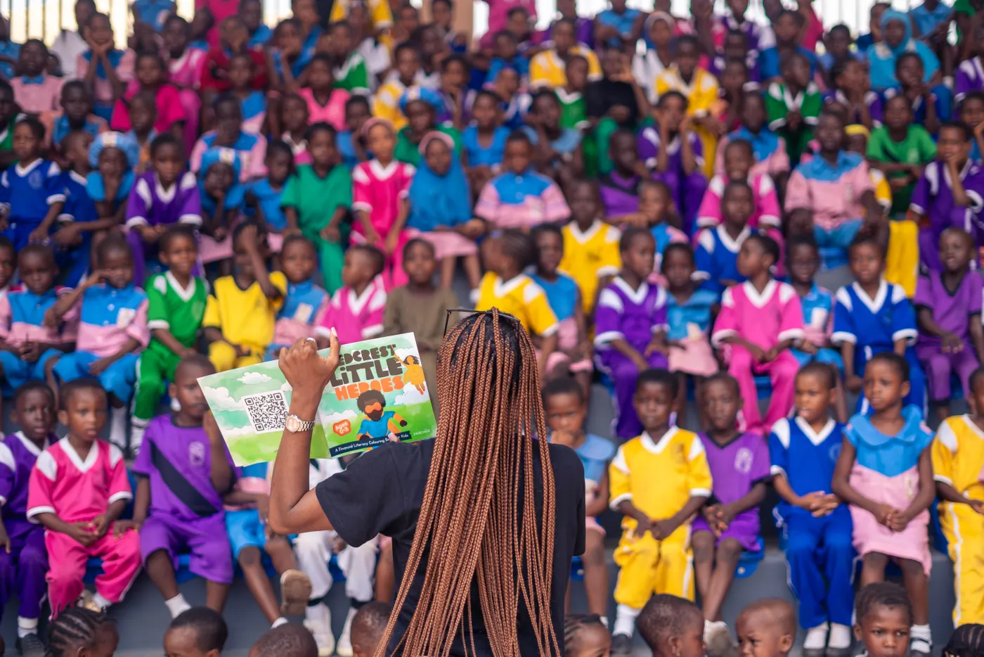 A facilitator presenting the Little Heroes book to schoolchildren at an outreach session